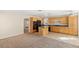 Spacious kitchen with island, black appliances, and adjacent living area for easy entertaining at 8005 Dover Shores Ave, Las Vegas, NV 89128