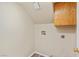 Functional laundry area with washer/dryer hookups and cabinet storage for added convenience at 8005 Dover Shores Ave, Las Vegas, NV 89128
