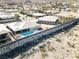 Aerial view of homes, pools, and palm trees in desert community near mountain range at 809 Lake Hill Dr, Boulder City, NV 89005