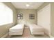 Bright bedroom featuring two twin beds, soft natural light and double door closet at 809 Lake Hill Dr, Boulder City, NV 89005