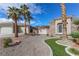 Spacious front yard with rock landscape, artificial grass, mature palm trees, and mountain views at 809 Lake Hill Dr, Boulder City, NV 89005