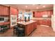 Spacious kitchen with wood cabinetry, granite countertops, a center island, and double ovens at 809 Lake Hill Dr, Boulder City, NV 89005