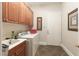 Functional laundry room boasts tile floors, sink, and plenty of cabinet storage space at 809 Lake Hill Dr, Boulder City, NV 89005