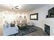 Comfortable living room with plush seating, decorative rug, fireplace, and stairway access at 809 Lake Hill Dr, Boulder City, NV 89005