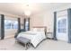 Bright main bedroom with a luxurious chandelier, neutral palette, and access to outdoor views at 809 Lake Hill Dr, Boulder City, NV 89005