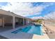 Inviting backyard featuring a pool and jacuzzi with a covered patio and desert landscape at 809 Lake Hill Dr, Boulder City, NV 89005
