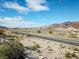 Picturesque view of highway, mountains, and desert landscape under blue sky at 809 Lake Hill Dr, Boulder City, NV 89005