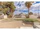 Large, private backyard with desert landscaping, mature trees, and ample space for recreation or relaxation at 8198 Palmada Dr, Las Vegas, NV 89123