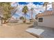 Expansive backyard featuring desert landscaping, palm trees, and a patio area perfect for outdoor dining and entertaining at 8198 Palmada Dr, Las Vegas, NV 89123