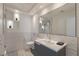 Modern bathroom with geometric tile, a large mirror, and sleek gray vanity at 8198 Palmada Dr, Las Vegas, NV 89123