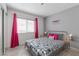 Comfortable bedroom featuring a full bed, ample window light, and modern decor at 8198 Palmada Dr, Las Vegas, NV 89123