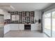 Contemporary kitchen with white cabinets, stainless steel appliances, and geometric backsplash at 8198 Palmada Dr, Las Vegas, NV 89123