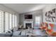 Bright living room with fireplace, stylish seating, and ample natural light through shutters at 8198 Palmada Dr, Las Vegas, NV 89123