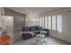 Comfortable living room with a gray sofa, sheer curtains, and a glass coffee table at 8198 Palmada Dr, Las Vegas, NV 89123