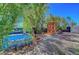 Picturesque backyard includes mature landscaping, a small pool, a seating area, and decorative accents at 8633 Radiant Ruby Ave, Las Vegas, NV 89143