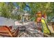 An inviting backyard featuring a unique stone patio, firepit, bench and playset with slide at 8633 Radiant Ruby Ave, Las Vegas, NV 89143