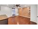 A bright bedroom with a ceiling fan, wood floors, and a wood accent wall at 8633 Radiant Ruby Ave, Las Vegas, NV 89143