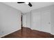 Bedroom with wood floors, a ceiling fan, a closet and neutral colored walls at 8633 Radiant Ruby Ave, Las Vegas, NV 89143
