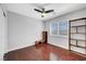 Bedroom with a ceiling fan, wood floors, a closet and built in shelving unit at 8633 Radiant Ruby Ave, Las Vegas, NV 89143