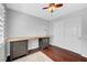 Bright bedroom with a ceiling fan, wood floors, a window, and a large closet at 8633 Radiant Ruby Ave, Las Vegas, NV 89143