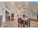 Open-concept dining area with elegant lighting, staircase access, and seamless flow to adjacent rooms at 8633 Radiant Ruby Ave, Las Vegas, NV 89143