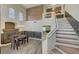 Elegant dining room with a striking fireplace, grand staircase, and ample natural light at 8633 Radiant Ruby Ave, Las Vegas, NV 89143