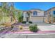 Charming two-story home featuring manicured landscaping and a welcoming entrance in a sunny setting at 8633 Radiant Ruby Ave, Las Vegas, NV 89143