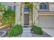Inviting front entrance with lush greenery and a decorative security screen door at 8633 Radiant Ruby Ave, Las Vegas, NV 89143