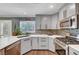 Well-appointed kitchen with gray cabinets, stainless steel appliances, and durable countertops at 8633 Radiant Ruby Ave, Las Vegas, NV 89143