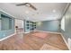 Open-concept living room with built-in shelving, tile floors, and access to other living spaces at 8633 Radiant Ruby Ave, Las Vegas, NV 89143