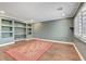 Living room featuring tile flooring, built-in shelving, modern recessed lighting, and neutral color at 8633 Radiant Ruby Ave, Las Vegas, NV 89143