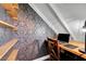 Cozy office nook featuring a built-in desk, shelving, and stylish wallpaper at 8633 Radiant Ruby Ave, Las Vegas, NV 89143