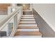 Carpeted stairs with white trim lead to the upper level, featuring a split-level landing at 8633 Radiant Ruby Ave, Las Vegas, NV 89143