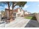 Private backyard with a concrete patio area and artificial turf, perfect for outdoor gatherings at 8729 Country View Ave, Las Vegas, NV 89129