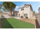 Beautiful backyard featuring a concrete patio, well-manicured artificial lawn, and privacy fence at 8729 Country View Ave, Las Vegas, NV 89129
