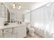 Bathroom with a modern vanity, a large mirror, and a shower with a patterned curtain at 8729 Country View Ave, Las Vegas, NV 89129