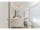 Bathroom with modern vanity, large mirror, and shower with patterned curtain at 8729 Country View Ave, Las Vegas, NV 89129