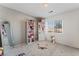 Bright bedroom with a large window, plush carpet, and ample storage with shelving at 8729 Country View Ave, Las Vegas, NV 89129