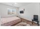 Bright bedroom features neutral walls, a patterned rug, and a comfortable chair at 8729 Country View Ave, Las Vegas, NV 89129