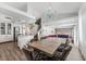 Spacious dining room featuring a chandelier, a large table with comfortable seating, and hardwood floors at 8729 Country View Ave, Las Vegas, NV 89129