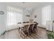 Bright dining room with a chandelier, hardwood floors, large windows, and comfortable seating at the dining table at 8729 Country View Ave, Las Vegas, NV 89129