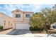 Charming two-story home showcasing a well-maintained exterior, two-car garage, and beautiful front yard landscaping at 8729 Country View Ave, Las Vegas, NV 89129