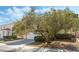 Two-story home with a well-manicured lawn, mature trees, and a paved driveway leading to the garage at 8729 Country View Ave, Las Vegas, NV 89129