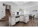 Kitchen featuring granite countertops, stainless steel appliances, wood-look floors and access to the living room at 8729 Country View Ave, Las Vegas, NV 89129