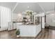 Bright kitchen boasts white cabinets, granite countertops, stainless steel appliances, and wood-look flooring at 8729 Country View Ave, Las Vegas, NV 89129