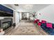 Spacious living area featuring hardwood floors, a modern fireplace, and seamless flow into the kitchen and dining room at 8729 Country View Ave, Las Vegas, NV 89129