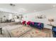 Open-concept living area featuring hardwood floors, plush seating, and seamless flow into the kitchen and dining room at 8729 Country View Ave, Las Vegas, NV 89129