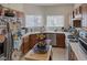 Galley style kitchen featuring wood cabinets, white countertops and stainless steel appliances at 8970 Tom Noon Ave, Las Vegas, NV 89178