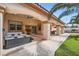 Covered patio with a hot tub, outdoor seating, and a well-manicured lawn for outdoor enjoyment at 9611 Trattoria St, Las Vegas, NV 89178