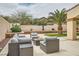 Stylish backyard with outdoor seating and palm tree, perfect for relaxing at 9611 Trattoria St, Las Vegas, NV 89178